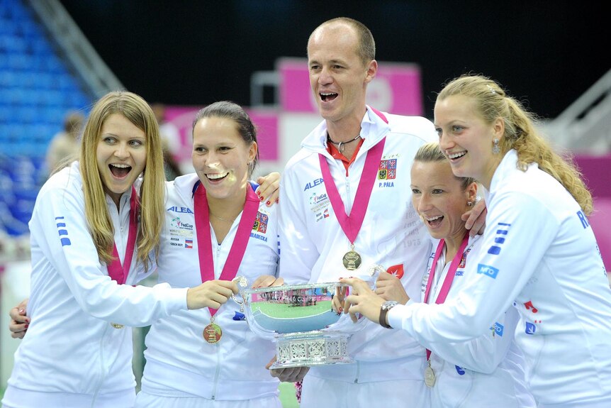 Czech Republic players and team captain hold the Fed Cup trophy.