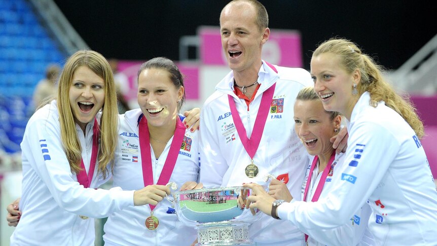 Czech Republic players and team captain hold the Fed Cup trophy.