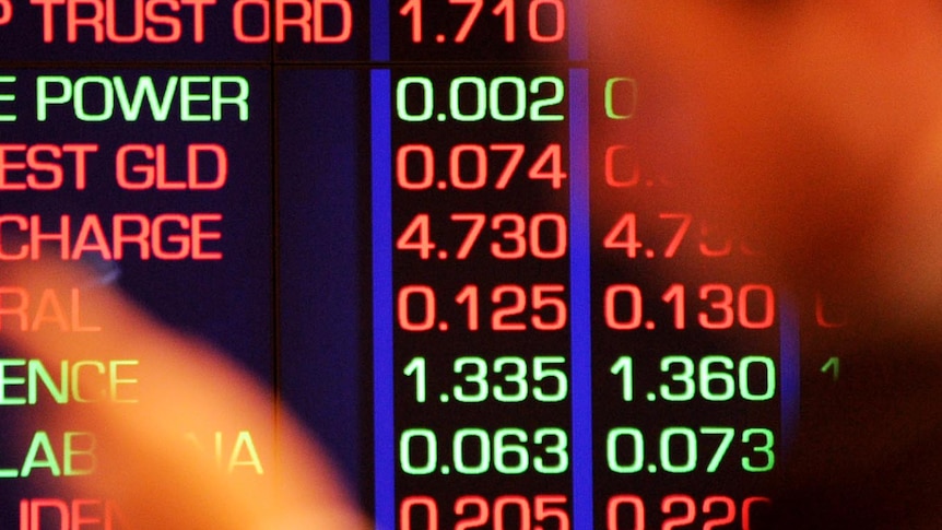 Office-worker watches share prices at the ASX in Sydney