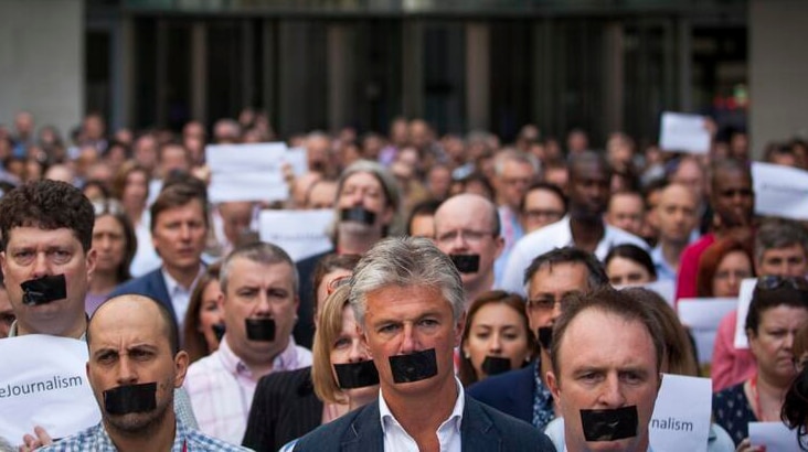 Staff from The Huffington Post Canada pose as part of the #FreeAJStaff campaign.