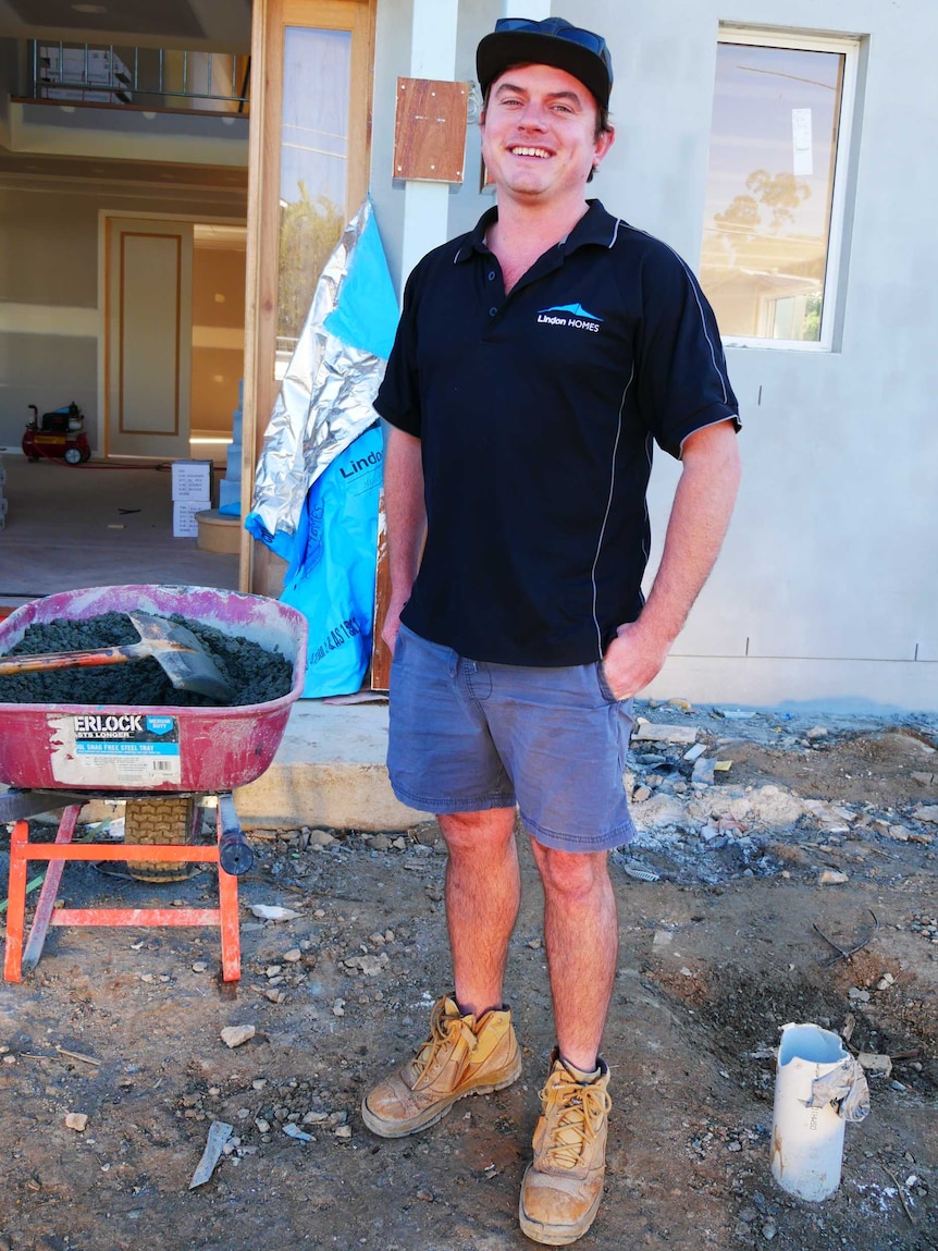 Young tradie smirks at the camera totally chuffed to have his picture taken