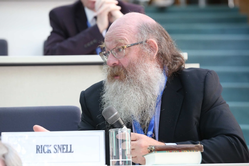 Close up of Rick Snell speaking at a conference in India