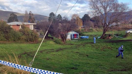 Police search the  back area of a house in Bridgewater, Tasmania, after a suspected murder.