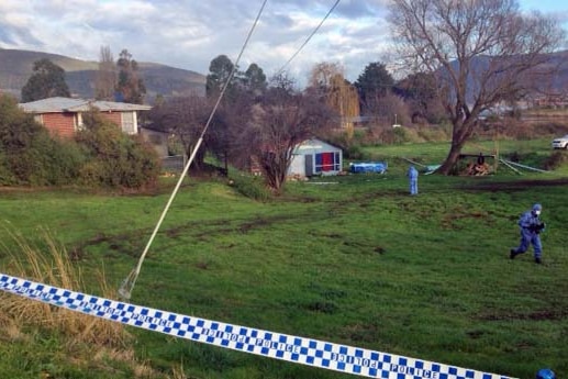 Police search the  back area of a house in Bridgewater, Tasmania, after a suspected murder.