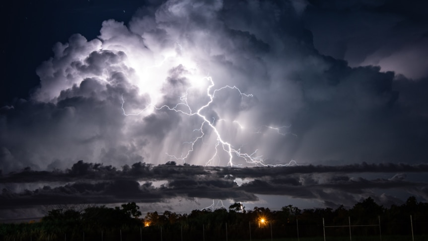 Lightning bolts over water.