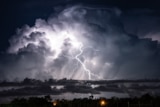 Lightning bolts over water.