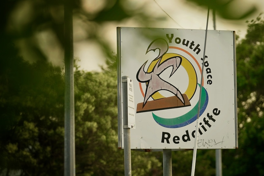 A sign for Redcliffe Area Youth Space, surrounded by trees.