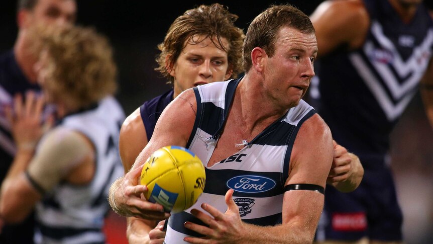 Geelong's Steve Johnson is tackled by Fremantle Nathan Fyfe