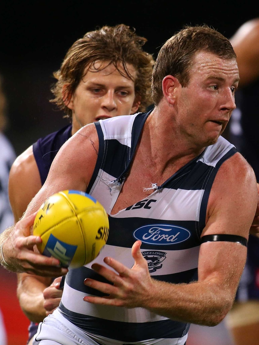 Geelong's Steve Johnson is tackled by Fremantle Nathan Fyfe