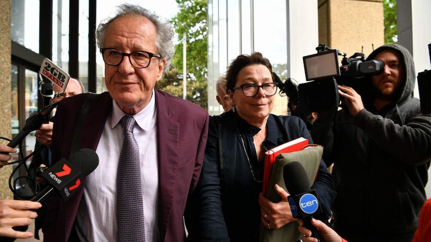 A man walking next to a woman outside a court building