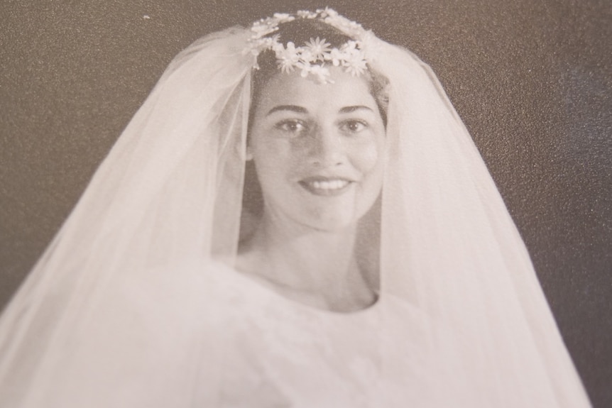 A black and white photo of a bride with a veil.