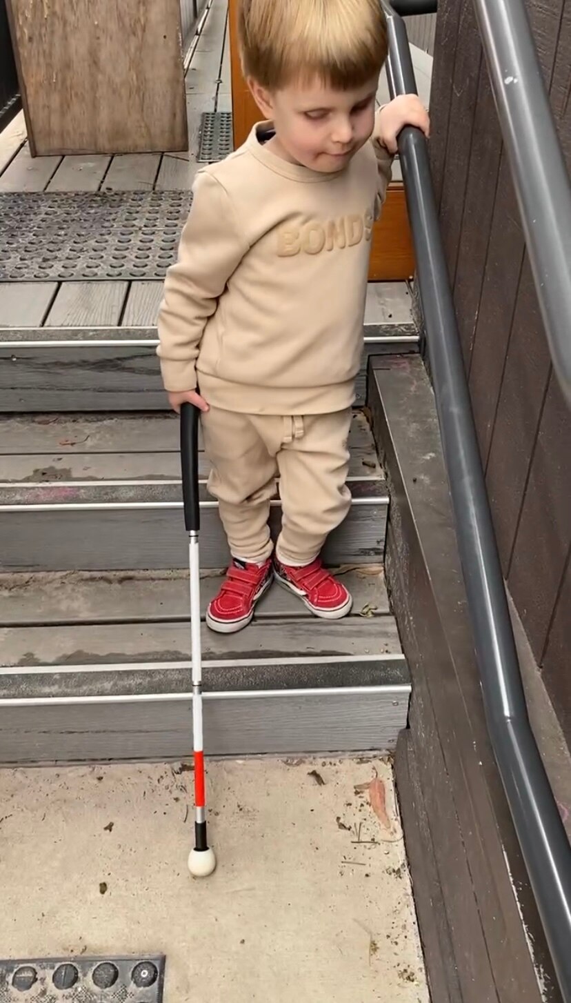 A young boy with a cane