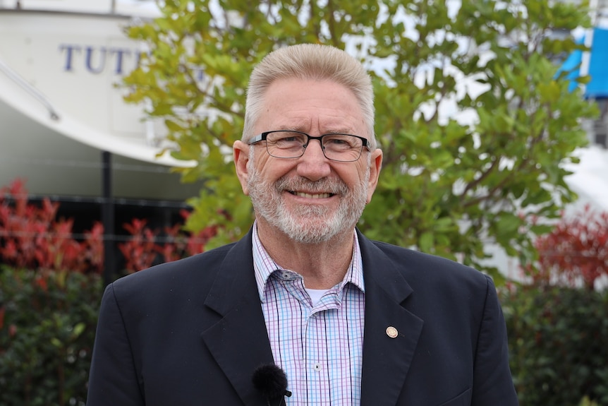 Coomera MP Michael Crandon standing in front of a tree