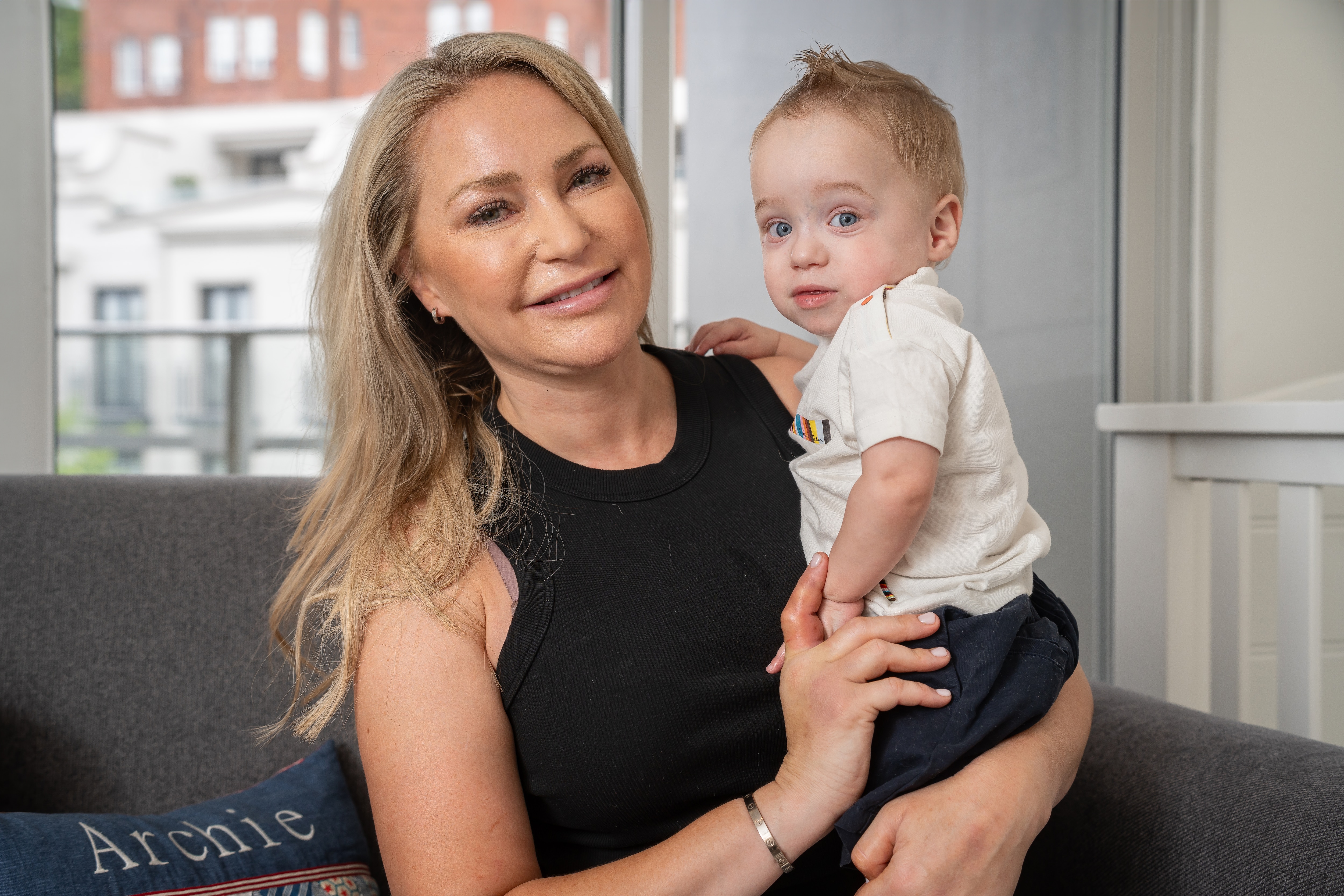 a woman and a baby on a lounge