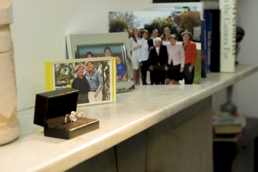 Wedding rings of Christine Forster and Virginia Flitcroft sit upon the mantlepiece.