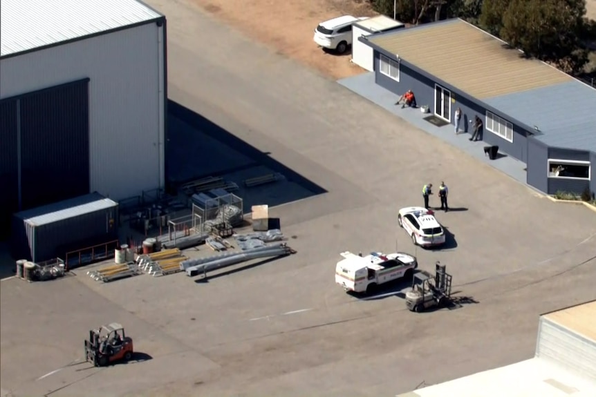 An aerial image of police cars at an industrial site