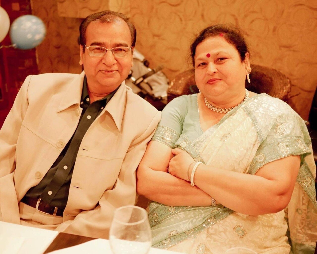 Dinesh and Kanak Saxena sitting next to each other at dinner.