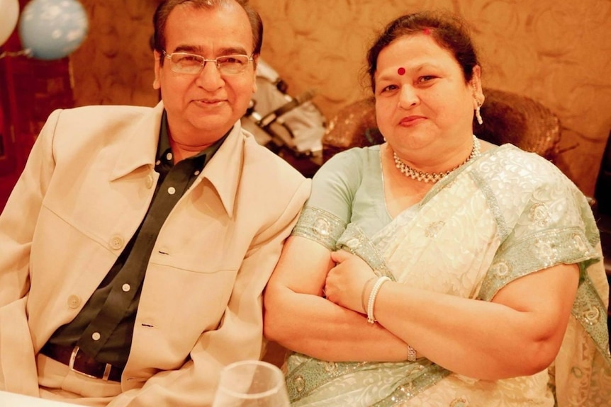 Dinesh and Kanak Saxena sitting next to each other at dinner.