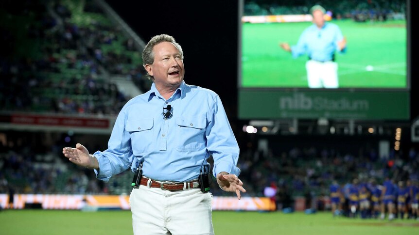 Andrew Forrest stands in the middle of Perth Oval, addressing the crowd through the PA.