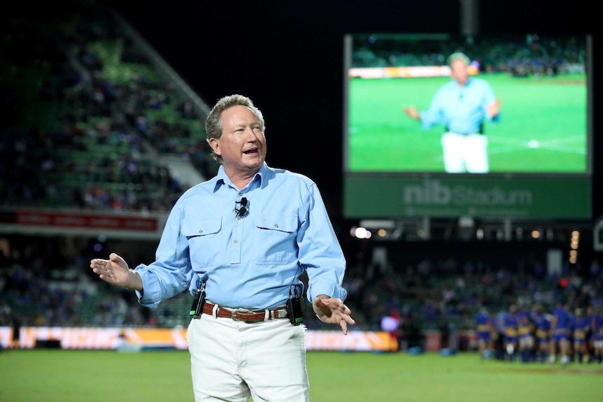 Andrew Forrest stands in the middle of Perth Oval, addressing the crowd through the PA.