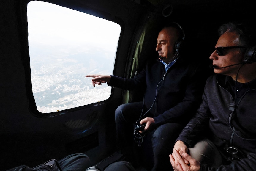US Secretary of State Antony Blinken and Turkish Foreign Minister Mevlut Cavusoglu sit in a helicopter.
