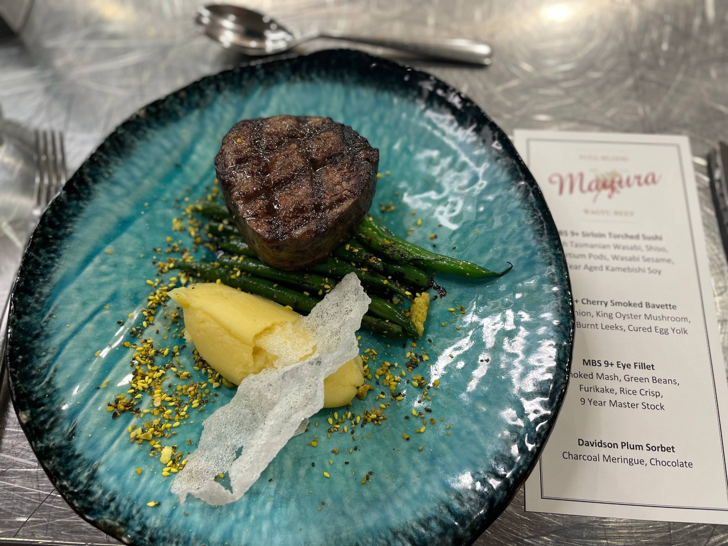 golf A green plate with charred beef and vegetables