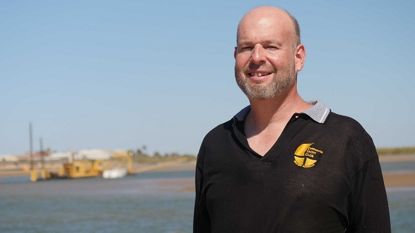 Carnarvon Yacht Club general manager Jim Williams standing in front of the community dredger