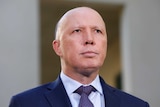 Peter Dutton looks into the distance.