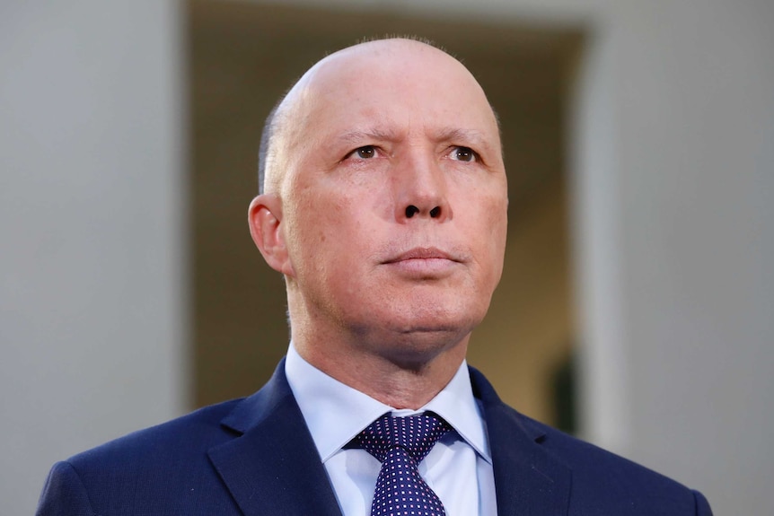 Peter Dutton looks into the distance.