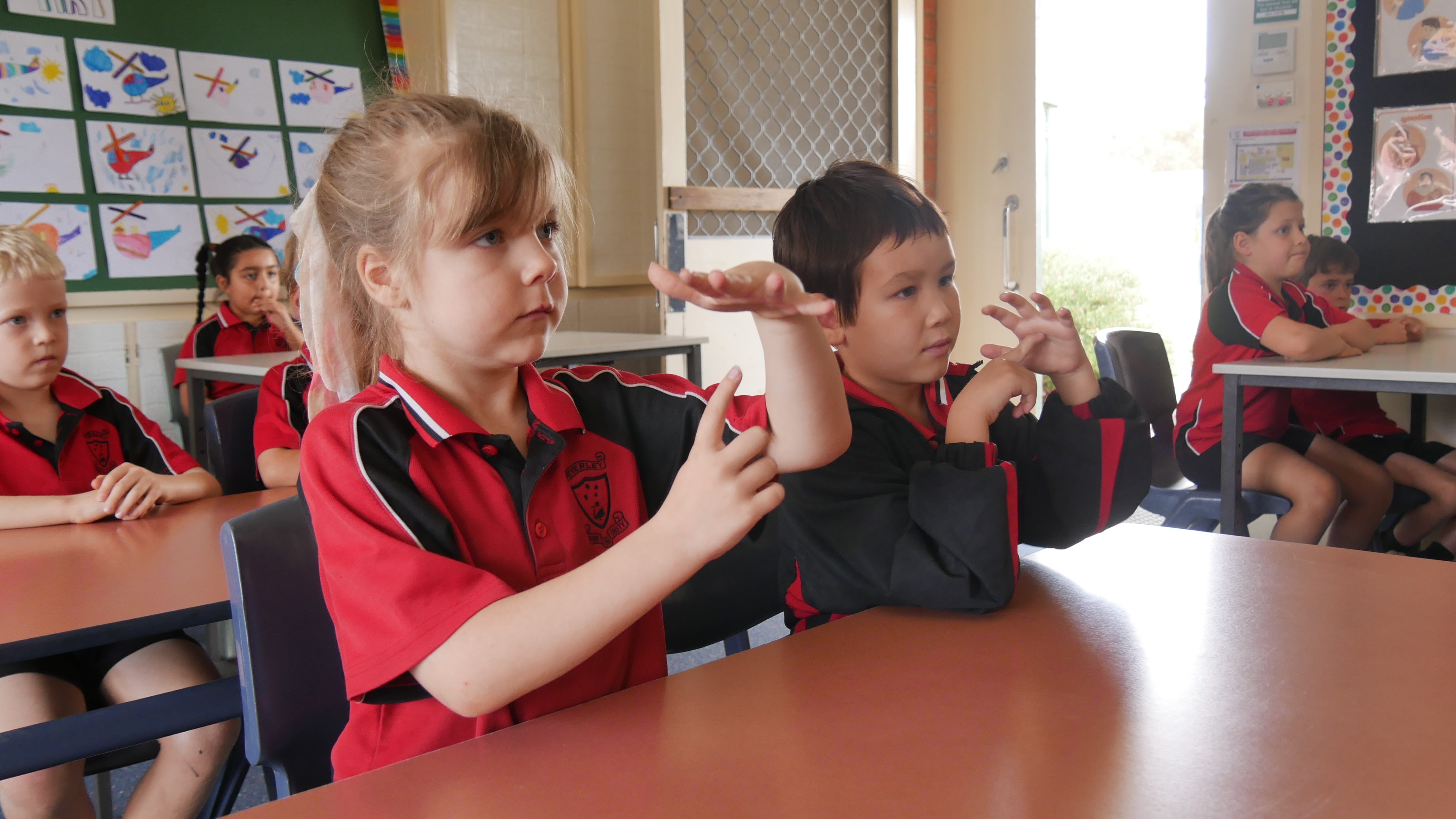 Children enjoy learning how to communicate with deaf people