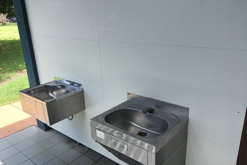 Two sinks outside a public toilet