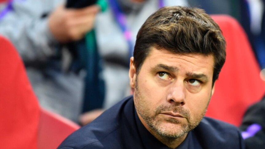 Tottenham manager Mauricio Pochettino sits in a matching dark suit and tie, looking up to the right, with a neutral expression.
