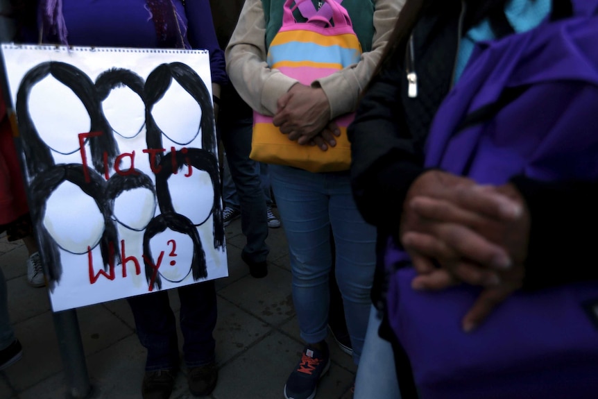 A picture of seven faceless women and girls with black hair and the word "why?" written in red.