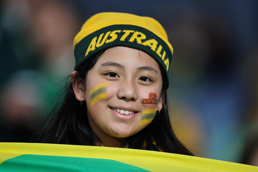 A young female football fan in the stands