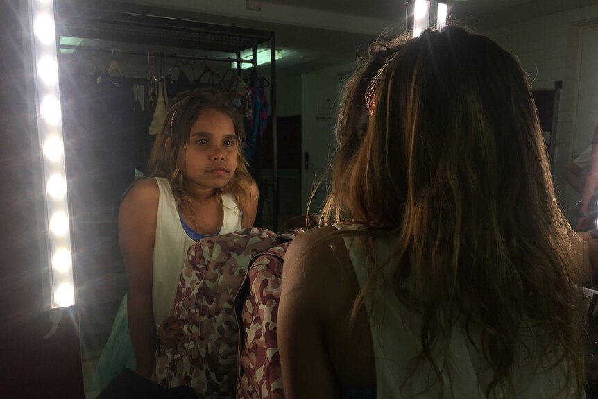 Model Cheyenne Shaw looks at her reflection in a mirror