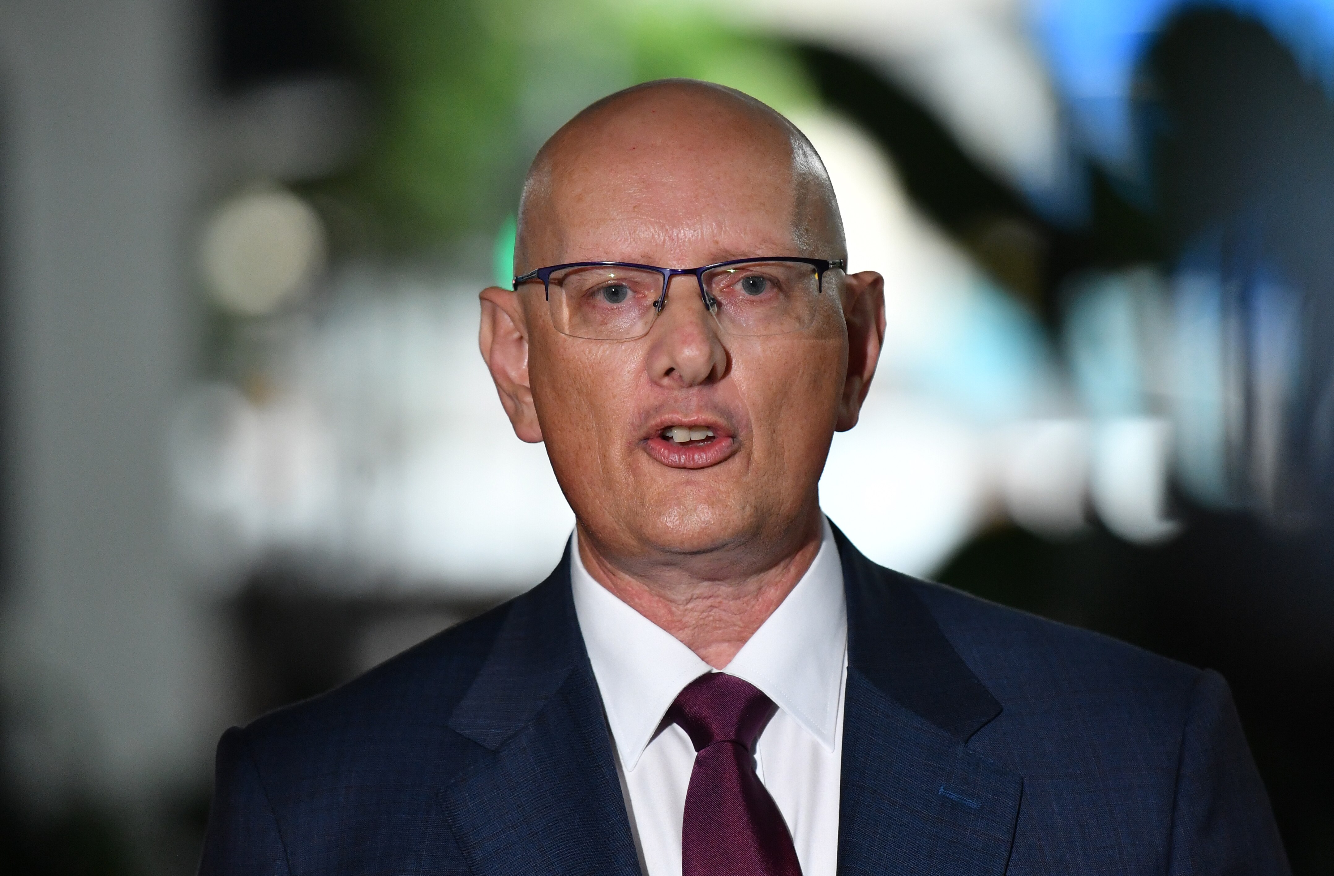 A balm man in a suit.