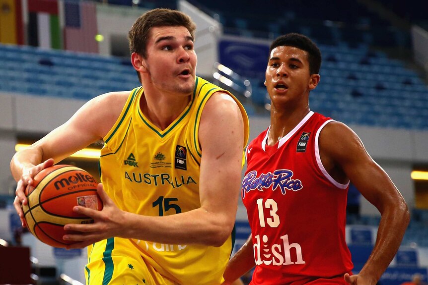 Australia's Isaac Humphries drives against Puerto Rico's Nick Berry at 2014 under-17 basketball world titles