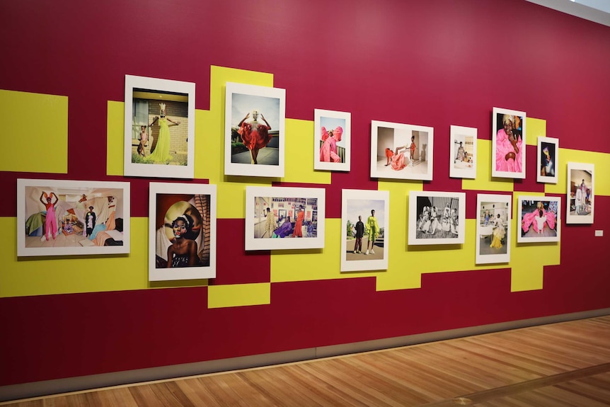 A brightly coloured wall of photographs shows pictures of Sudanese-born Australian, Adut Akech.