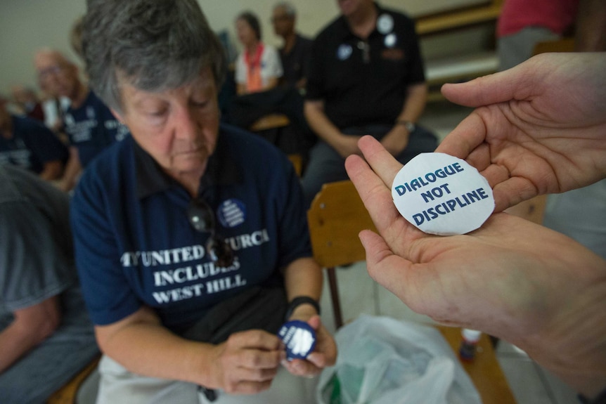 Supporters put stickers on some buttons prior to a meeting between Gretta Vosper and United Church officials.