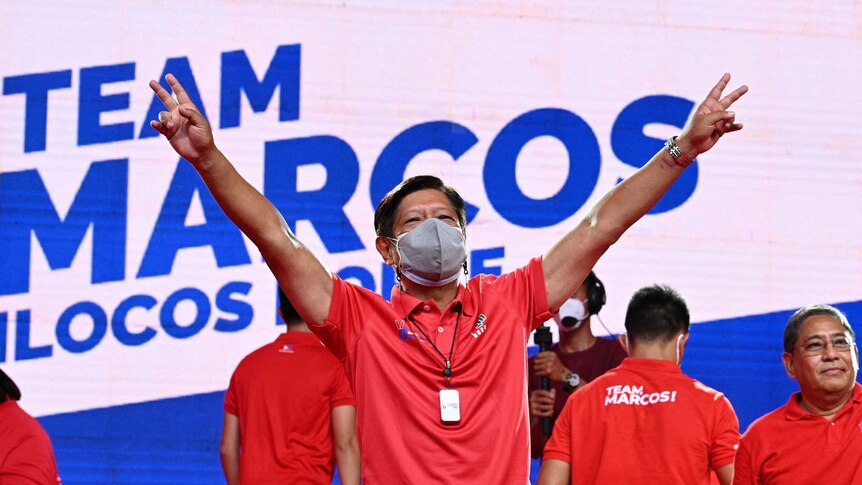 Ferdinand Marcos Jr in front of a 'team Marcos' sign