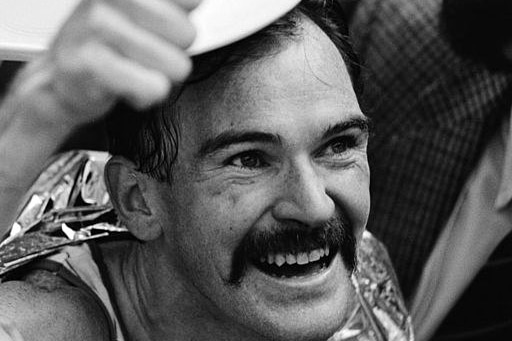 Robert de Castella looks up to the crowd after a marathon in 1983