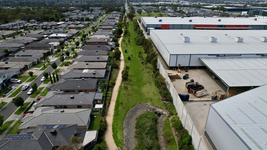 Aerial shot of an industrial area sitting directly across from a housing estate.