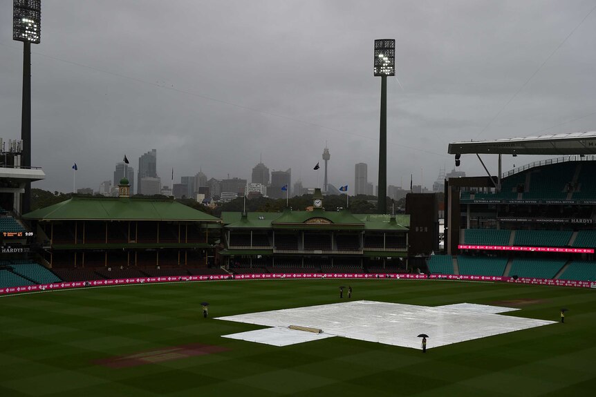 The covers are on and the rain is falling at the SCG.