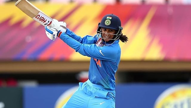 Indian cricketer Smriti Mandhana hits a cover drive while batting.