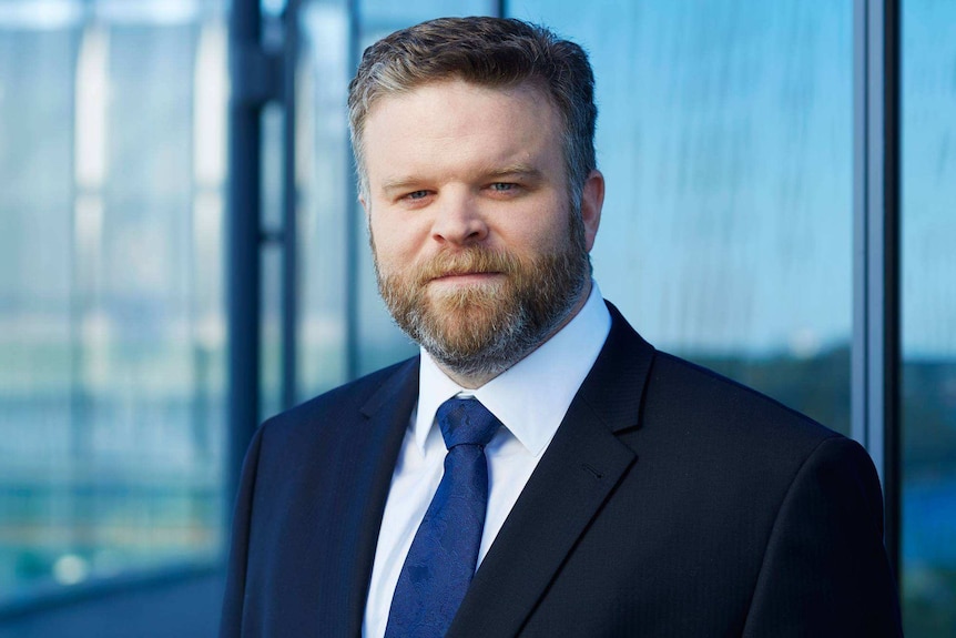 A headshot of lawyer Luke O'Callaghan wearing a suit