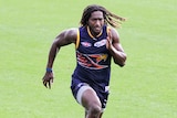 An image of West Coast ruckman Nic Naitanui running on a grass surface.