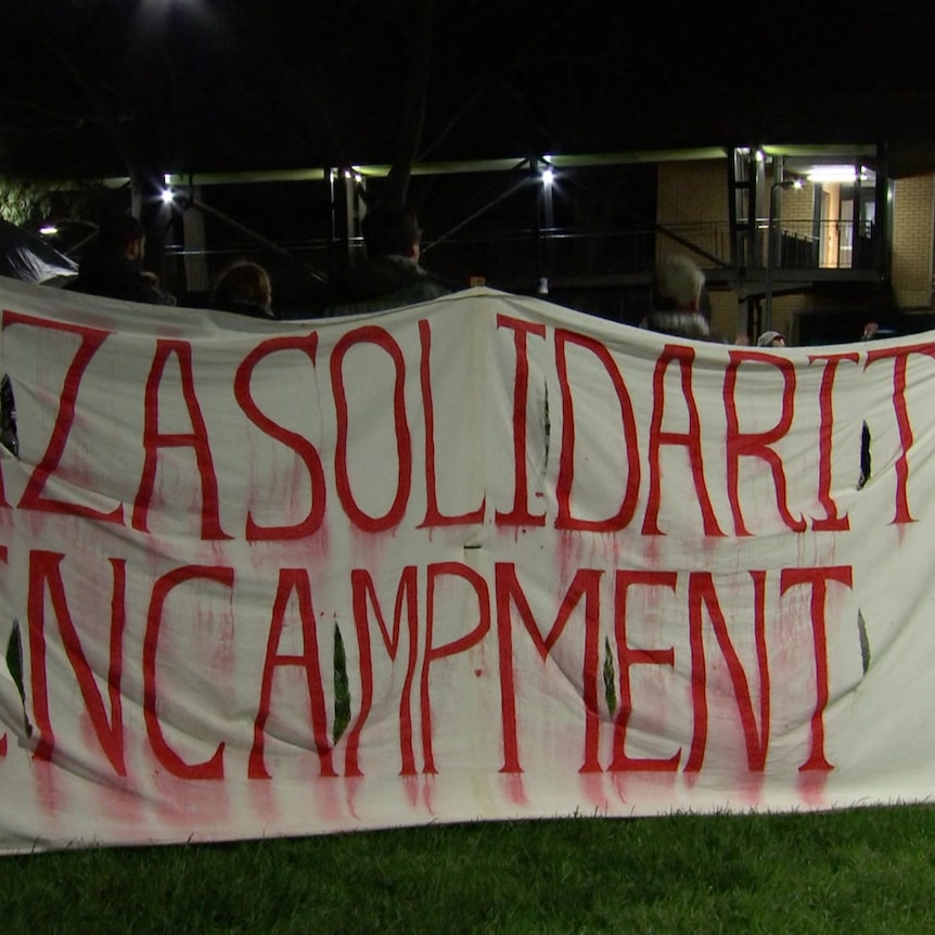 A banner with Gaza solidarity encampment painted on.