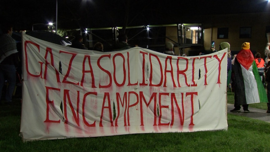 A banner with Gaza solidarity encampment painted on.