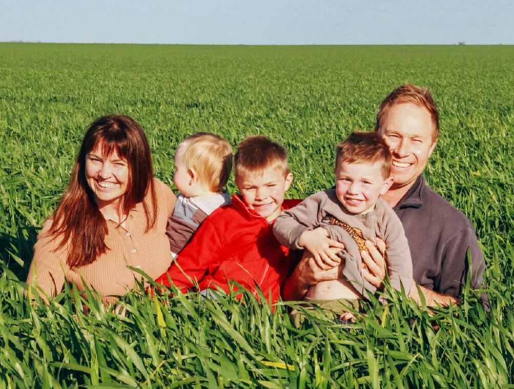 Smiling family photo in grain crop