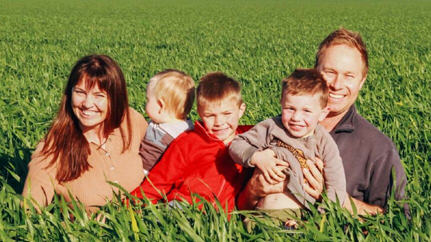 Smiling family photo in grain crop